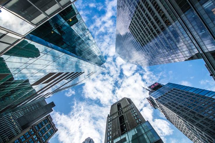 bottom view shot of glass skyscrapers under blue cloudy sky